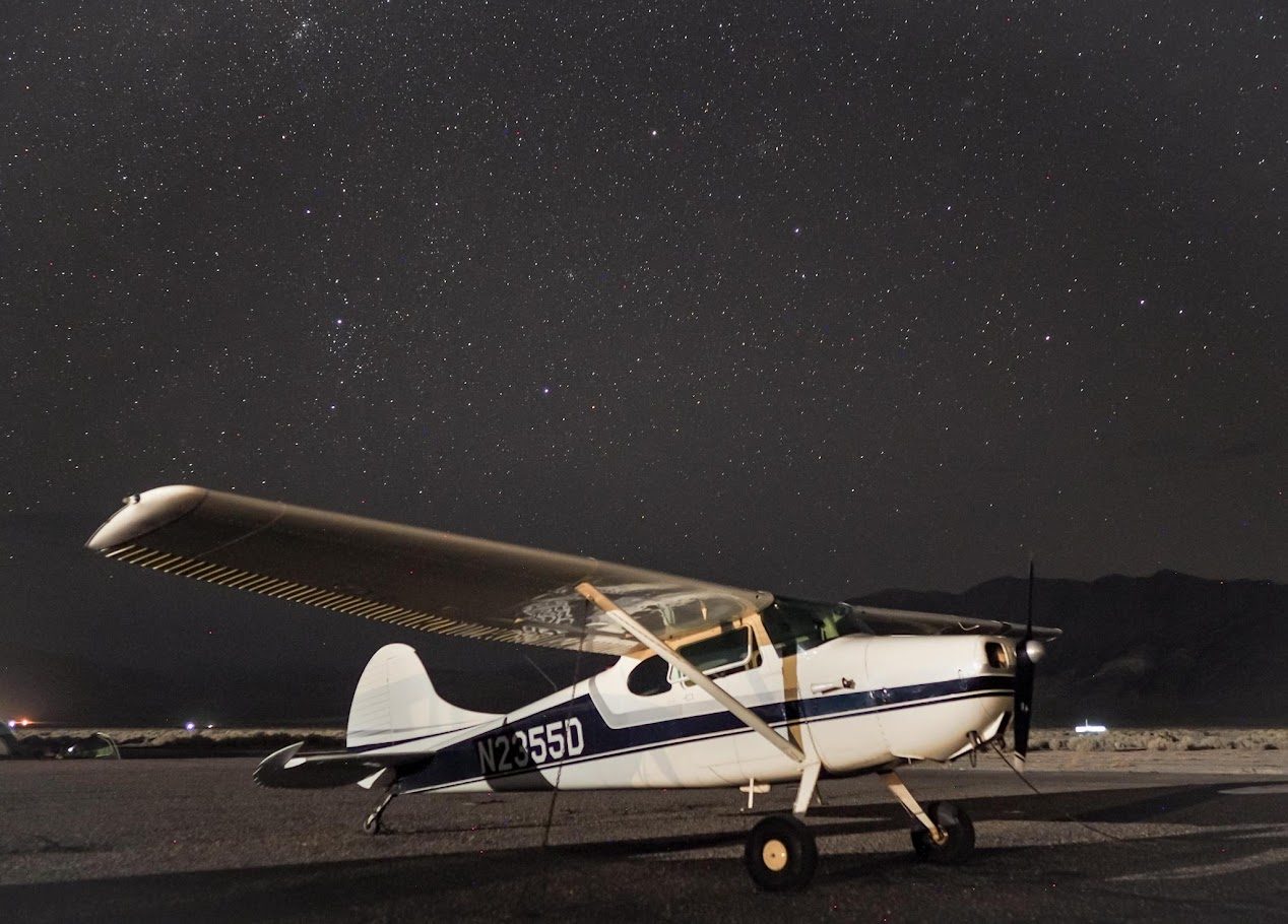 Cessna 170 N2355D parked under a star-filled night sky